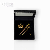 Gold crown and scepters in a black display box with 'Crowns & Regalia' branding.